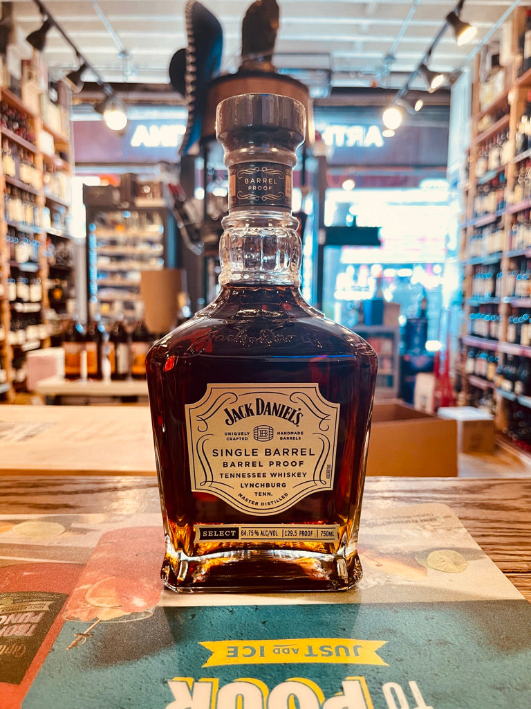 Jack Daniel's Single Barrel 750mL 129.5 a short squared long neck clear glass bottle with a gold label and wooden top