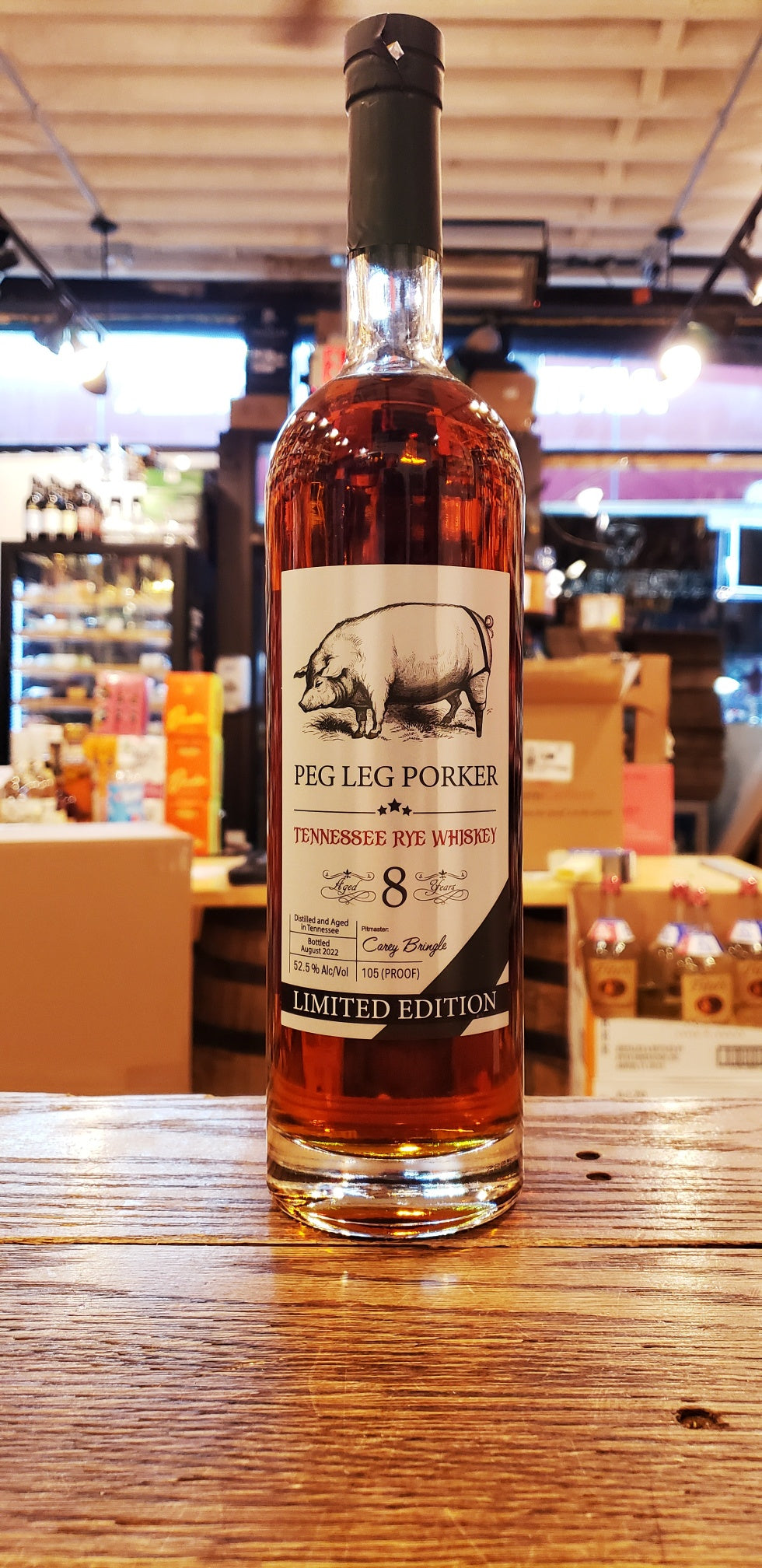 Peg Leg Rye Limited Edition 8yr 750mL a tall slender clear bottle with a silver label with the image of a peg legged pig and a dark green top