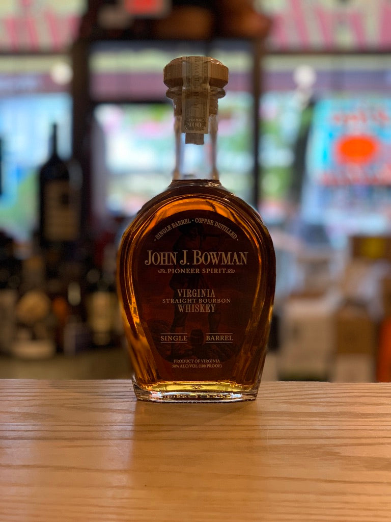 John J Bowman Single Barrel 750mL short flat surfaced clear glass bottle with rounded shoulders and golden lettering and a wooden top 