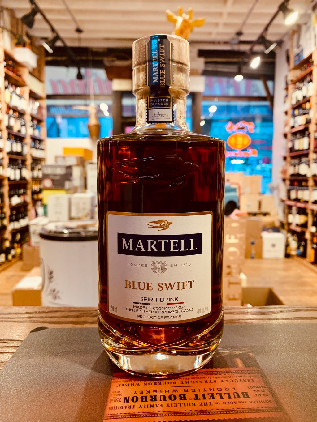 Martell Blue Swift VSOP 750mL a squat round shouldered bottle with a white label and wooden top