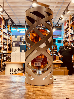 Glenfiddich 30Yr Suspended Time 750mL the backside of  an artistically designed silver open cylinder with a clear angulated clear bottle suspended inside of it