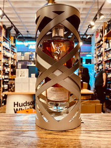 Glenfiddich 30Yr Suspended Time 750mL an artistically designed silver open cylinder with a clear angulated clear bottle suspended inside of it  