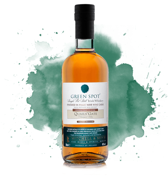 Green Spot Single Pot Quail's Gate Whiskey 750mL a short high rounded shouldered clear bottle with a white label with a green spot on it. 