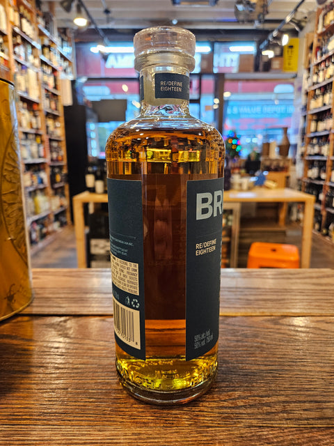 Bruichladdich 18 Aged Years Islay Whisky 750mL a cylinder shaped clear glass bottle with a blue label and glass top