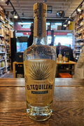 El Tequileno Platino Blanco 750mL a clear glass bottle with rounded shoulders and a beige label and wood top