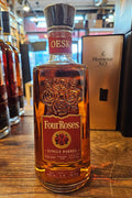 Four Roses OESK Single Barrel 100 Proof Kentucky Straight Bourbon Whiskey 750mL squared shouldered clear glass bottle with a red label and a wooden top.