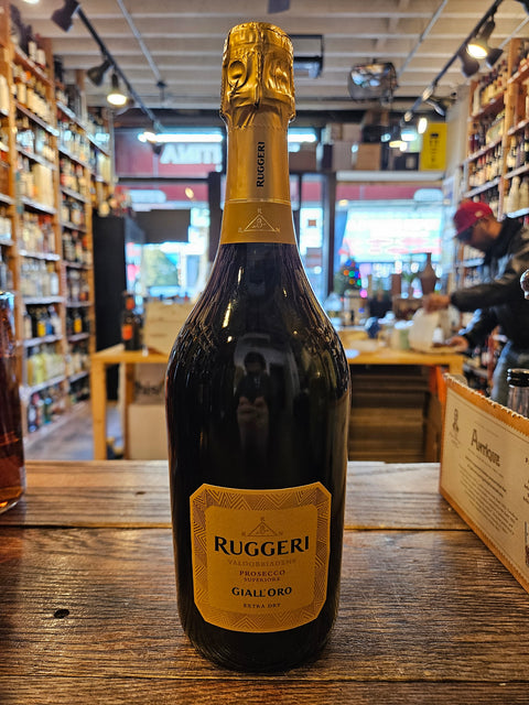 Ruggeri Giall'oro Prosecco 750mL a dark glass champagne shaped bottle with a yellow label and yellow top