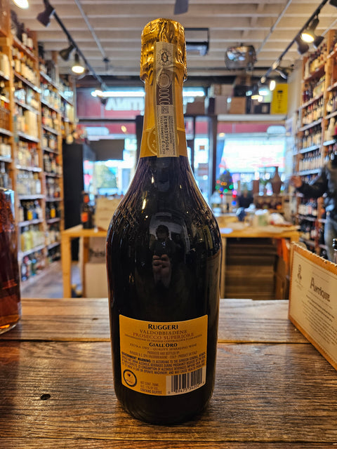 Ruggeri Giall'oro Prosecco 750mL a dark glass champagne shaped bottle with a yellow label and yellow top