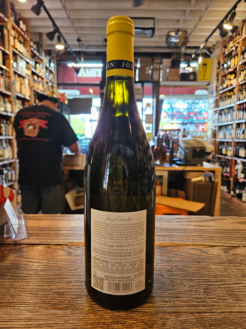 Wine bottle with a yellow label on a wooden surface in a store setting