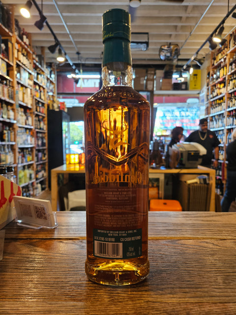 Bottle of whiskey on a wooden surface with a store interior in the background
