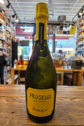 Prosecco bottle with Pasqua label on a wooden surface in a store setting