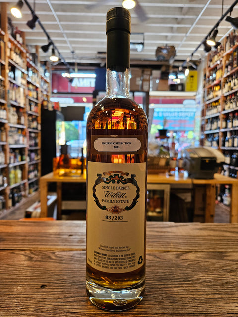 Bottle of whiskey on a wooden surface with a blurred indoor background