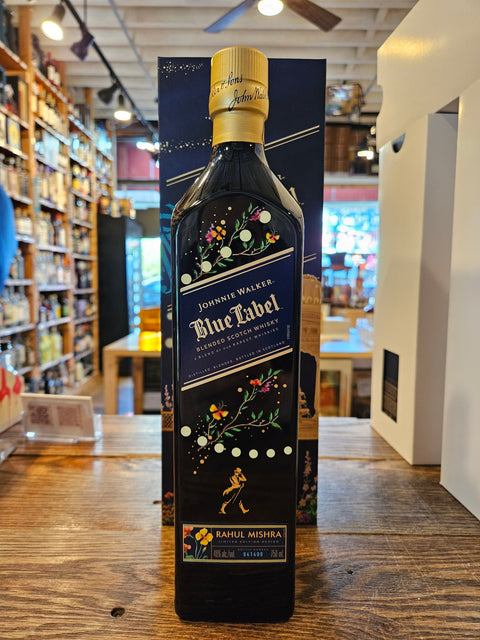 Johnnie Walker Blue Label bottle on a wooden surface with a blurred indoor background