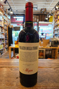 Bottle of wine with a label on a wooden surface in a store setting