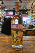 Bottle of Rosé de France wine with a colorful label on a wooden surface.