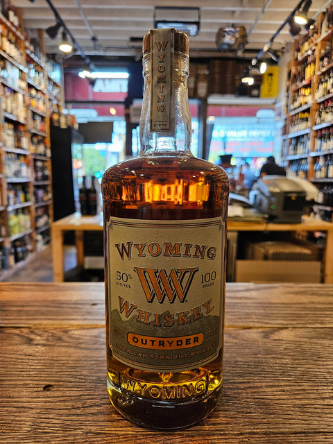 Bottle of Wyoming Whiskey on a wooden surface with a store interior in the background