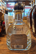 Patrón tequila bottle on a wooden surface with a blurred background