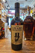 Bottle of Amaro Importante on a wooden surface with blurred store interior in the background