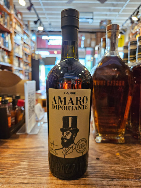 Bottle of Amaro Importante on a wooden surface with blurred store interior in the background