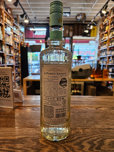 Bottle of George Dickel Rye on a wooden surface with a blurred bar background