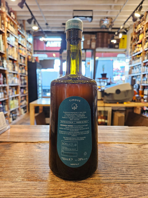 Bottle of alcohol on a wooden surface with a blurred indoor background