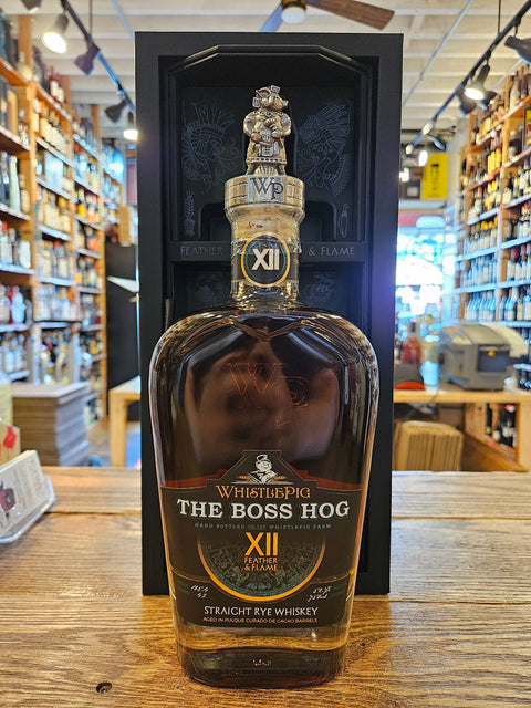 Bottle of 'The Boss Hog XII' whiskey on a wooden surface with a store interior in the background.