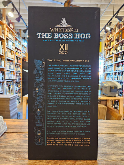 WhistlePig The Boss Hog XII whiskey bottle label on a wooden surface with a blurred store background.