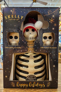 Two shot glasses shaped like skeletons in a decorative box with 'Skelly' branding.