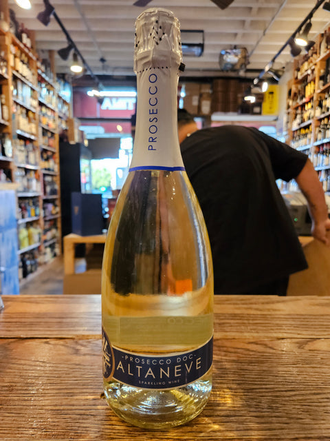 Bottle of Prosecco on a wooden surface with a store interior in the background