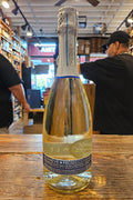 Bottle of Prosecco on a wooden surface with a blurred background