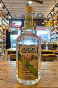 Bottle of Barton Naturals on a wooden surface with a store interior in the background