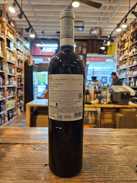 Wine bottle on a wooden surface with a blurred store interior in the background