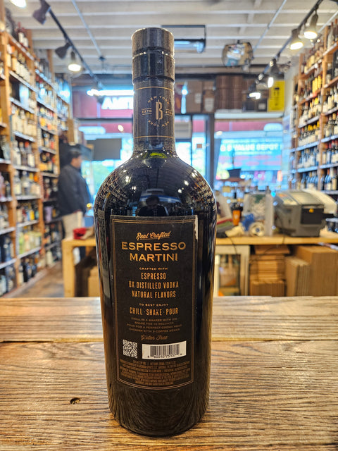 Bottle of Espresso Martini on a wooden surface with a store interior in the background
