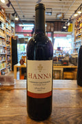 Bottle of Hanna wine on a wooden surface with a store interior in the background