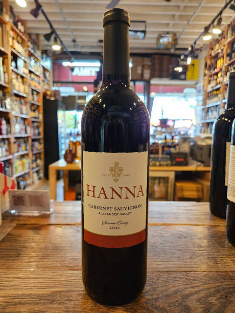 Bottle of Hanna wine on a wooden surface with a store interior in the background