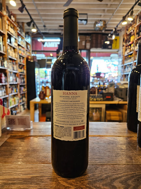 Bottle of Hanna wine on a wooden surface with a store interior in the background