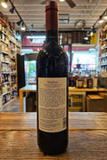Wine bottle with a label on a wooden surface in a store setting