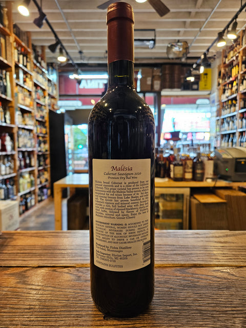 Wine bottle with a label on a wooden surface in a store setting