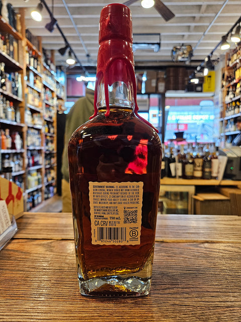 Bottle of alcohol with a label on a wooden surface, blurred store interior in the background