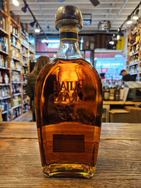 Bottle of Ballarat whiskey on a wooden surface with a store interior in the background