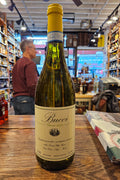 Wine bottle on a wooden surface with a blurred store interior in the background