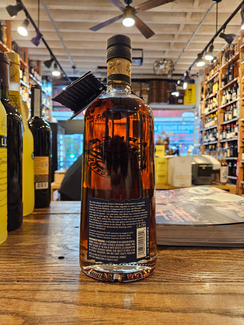 Bottle of whiskey on a wooden surface with a blurred bar background