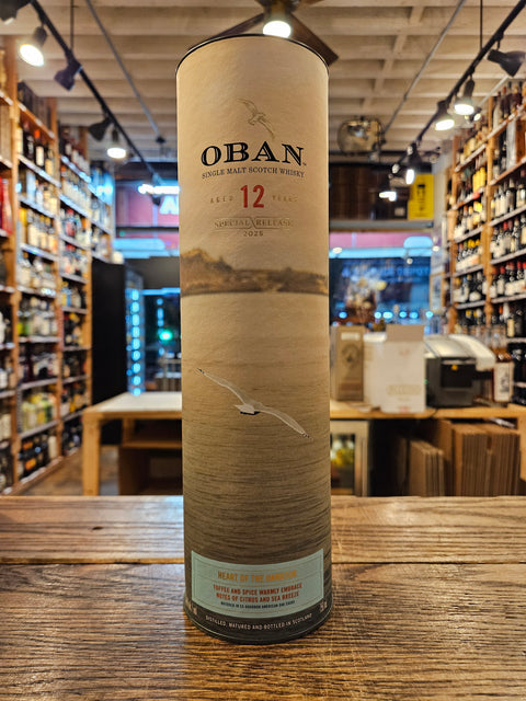Oban 12-year-old whisky bottle on a wooden surface with a store interior in the background