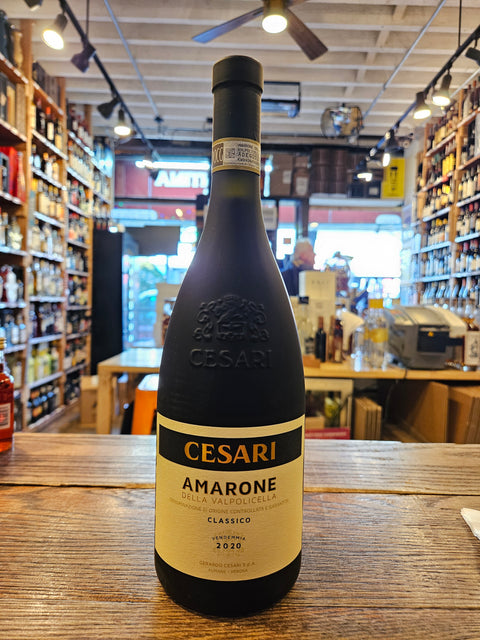 Bottle of Cesare Amarone wine on a wooden surface with a store interior in the background
