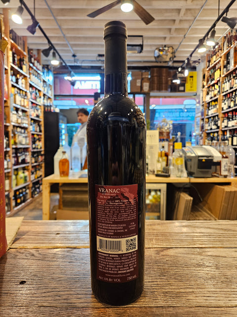 Wine bottle on a wooden surface with a store interior in the background