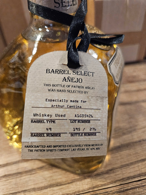 Tequila bottle with a label on a wooden surface