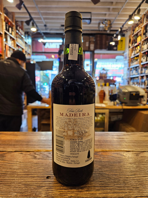 Bottle of Madeira wine on a wooden surface with a blurred indoor background