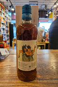 Bottle of Japanese Whisky on a wooden surface with a blurred store interior in the background