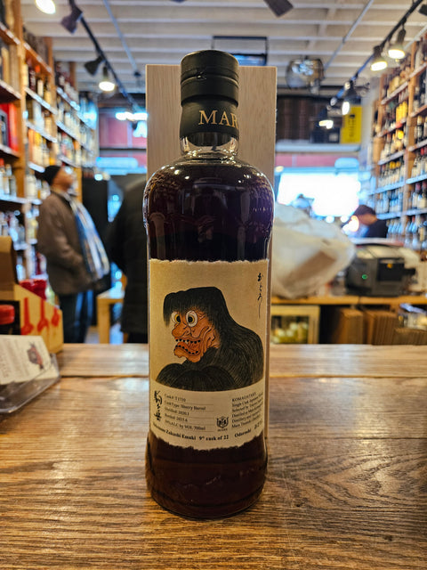Japanese Whisky bottle with label on a wooden surface in a store setting