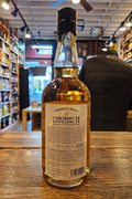 Bottle of whiskey on a wooden surface with a blurred store interior in the background